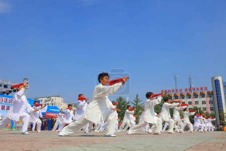 Photo for Luannan County - August 8, 2017: Taiji Kung Fu performance in a park, Luannan County, Hebei Province, china - Royalty Free Image