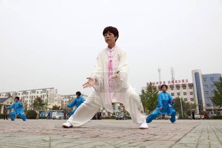 Photo for LUANNAN COUNTY, China - October 15, 2017: Taijiquan Exercise in the square, LUANNAN COUNTY, Hebei Province, China - Royalty Free Image