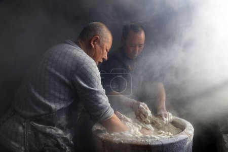 Foto de Luannan County - January 31, 2018: workers busy in producing vermicelli workshop, Luannan County, Hebei Province, Chin - Imagen libre de derechos