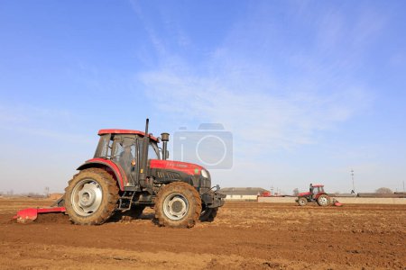 Photo for Luannan County - March 16, 2018: Rotocultivator in flat land in a farm, Luannan County, Hebei Province, Chines - Royalty Free Image