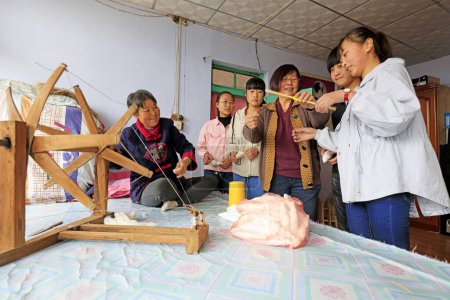 Photo for Luannan County - March 30, 2018: several junior high school students during a visit to the indigenous weaving process in Luannan County, Hebei Province, Chines - Royalty Free Image