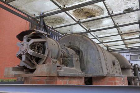 Photo for The rusty turbine generator lay idle in a corner of the factory - Royalty Free Image
