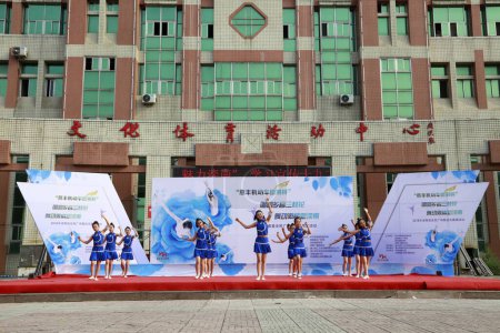 Photo for LUANNAN COUNTY, China - July 2, 2018: sports fitness dance performance in a park, LUANNAN COUNTY, Hebei Province, China - Royalty Free Image