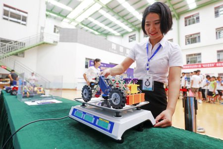Photo for LUANNAN COUNTY, China - July 20, 2018: staff measure car, at an innovative works competition, LUANNAN COUNTY, Hebei Province, China - Royalty Free Image