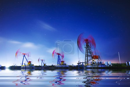 Photo for Oil pumping machinery in operation, crude oil extraction scene in the night, North China - Royalty Free Image