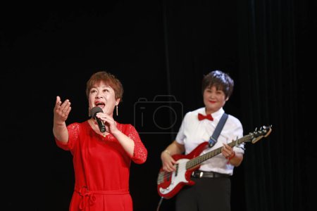 Photo for LUANNAN COUNTY, China - September 28, 2018: The song was performed at a party, LUANNAN COUNTY, Hebei Province, China - Royalty Free Image