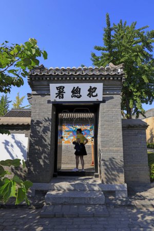 Photo for Qinhuangdao City, China - October 4, 2018: A girl is at the entrance of the ancient building's gate, Qinhuangdao City, Hebei Province, China - Royalty Free Image