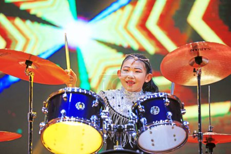 Photo for Luannan County - January 27, 2019: Girls play drums on shelves on the stage, Luannan County, Hebei Province, China - Royalty Free Image