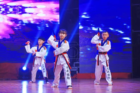 Photo for Luannan County - January 29, 2019: Children Wushu Kungfu Performance on the Stage, Luannan County, Hebei Province, China - Royalty Free Image