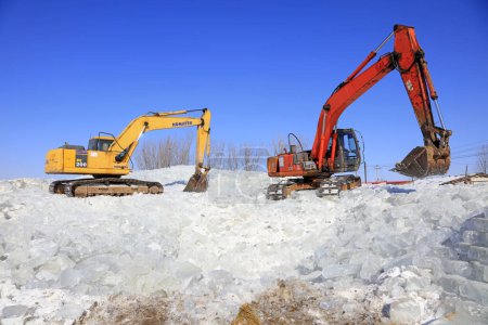 Photo for Luannan County - January 23, 2018: Excavator collate ice in the field, Luannan County, Hebei Province, Chin - Royalty Free Image