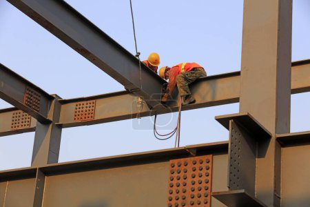 Photo for Luannan county - March 22, 2018: workers work on steel girders in a construction site, luannan county, hebei province, China - Royalty Free Image