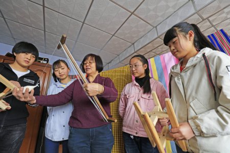 Photo for Luannan County - March 30, 2018: several junior high school students during a visit to the indigenous weaving process in Luannan County, Hebei Province, Chines - Royalty Free Image