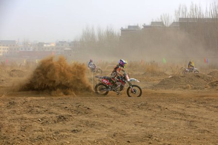 Photo for Luannan County - March 31, 2018: Cross-country motorbike field endurance race, Luannan County, Hebei Province, Chin - Royalty Free Image