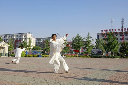 Photo for Luannan County - May 19, 2018: Chinese Taiji Sword performance on the square, Luannan County, Hebei Province, China - Royalty Free Image