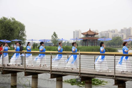 Photo for LUANNAN COUNTY, China - June 9, 2018: Cheongsam lady shows in the park, LUANNAN COUNTY, Hebei Province, China - Royalty Free Image
