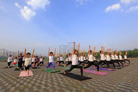 Téléchargez les photos : Comté de Luannan - 21 juin 2018 : Pratiquants de yoga dans le parc, la journée est la Journée internationale du yoga. Comté de Luannan, province du Hebei, Chine - en image libre de droit