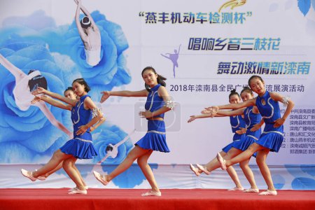 Photo for LUANNAN COUNTY, China - July 2, 2018: sports fitness dance performance in a park, LUANNAN COUNTY, Hebei Province, China - Royalty Free Image
