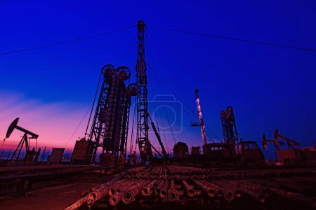 Photo for Oil pumping machinery in operation, crude oil extraction scene in the night, North China - Royalty Free Image