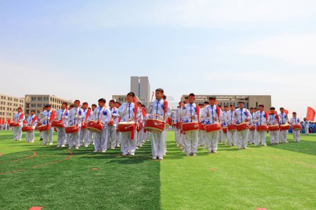 Photo for LUANNAN COUNTY, China - April 8, 2019: The percussion band is beating the drum at the sports meeting, LUANNAN COUNTY, Hebei Province, China - Royalty Free Image