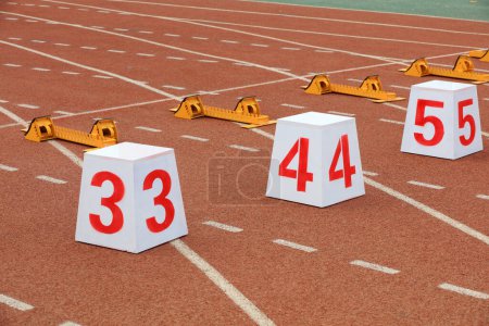 Photo for Track numbers and starters on the plastic track on the playground - Royalty Free Image