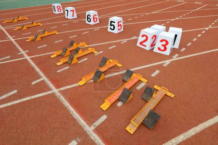 Photo for Track numbers and starters on the plastic track on the playground - Royalty Free Image