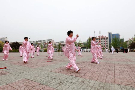 Photo for LUANNAN COUNTY, Hebei Province, China - April 29, 2019: people practice Taijiquan in the park square. - Royalty Free Image