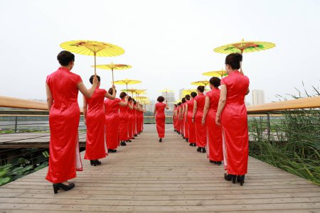 Photo for Chinese Cheongsam Walking Show in the Park, Luannan County, Hebei Province, China - Royalty Free Image
