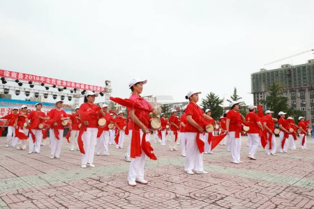 LUANNAN COUNTY, Hebei Province, China - August 8, 2019: Elderly fitness waist drum performance in the park square.