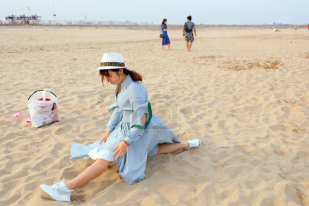 Photo for LUANNAN COUNTY, Hebei Province, China - May 3, 2019: A girl is playing on the beach. - Royalty Free Image