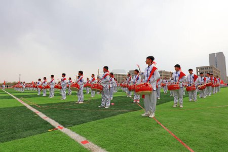 Photo for LUANNAN COUNTY, China - April 11, 2019: The percussion band is beating the drum at the sports meeting, LUANNAN COUNTY, Hebei Province, China - Royalty Free Image