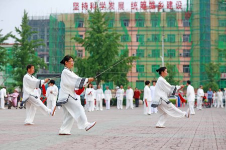 Photo for Luannan County - May 19, 2019: Chinese Tai Chi Sword Performing in Square, Luannan County, Hebei Province, China - Royalty Free Image