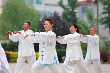 Photo for Luannan County - May 19, 2019: people doing traditional Tai Chi Chuan in the park for healthy, traditional Chinese martial arts concept, Luannan County, Hebei Province, Chin - Royalty Free Image