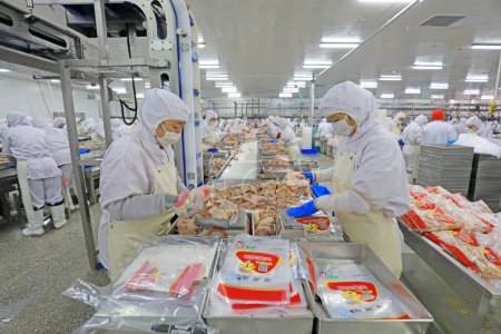 Photo for Luannan County, China - June 18, 2019: Workers are busy on the broiler processing line, Luannan County, Hebei Province, China - Royalty Free Image
