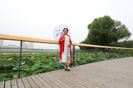 Photo for Luannan County, China - July 9, 2019: A lady was playing on the trestle in the park, Luannan County, Hebei Province, China - Royalty Free Image