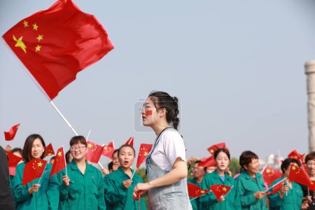 Photo for Luannan County, China - 12 July, 2019: People waved flags in the square, Luannan County, Hebei Province, China - Royalty Free Image