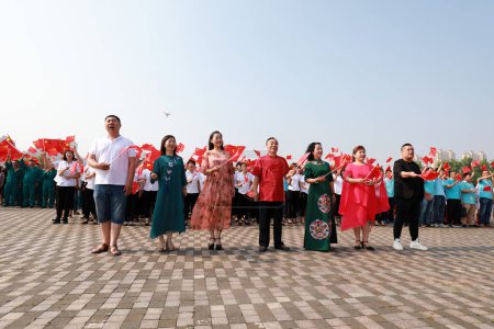 Photo for Luannan County, China - 12 July, 2019: People sang patriotic songs in the square, Luannan County, Hebei Province, China - Royalty Free Image