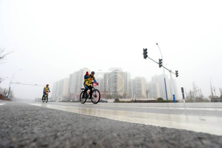 Téléchargez les photos : COMTÉ DE LUANNAN, province du Hebei, Chine - 23 novembre 2019 : Les cyclistes tentent d'aller de l'avant, sur un site de compétition cycliste sur route. - en image libre de droit
