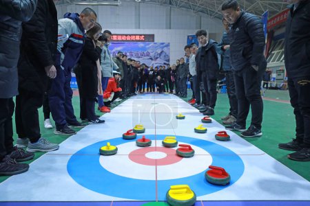 Photo for LUANNAN COUNTY, Hebei Province, China - November 26, 2019: The indoor land curling competition was held at a staff meeting. - Royalty Free Image