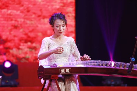Photo for LUANNAN COUNTY, Hebei Province, China - December 30, 2019: The performance of traditional Chinese instrumental Guzheng music on stage. - Royalty Free Image