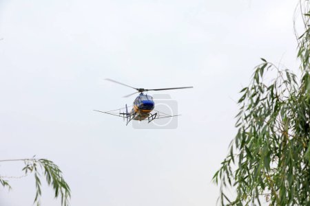 Photo for Agricultural helicopters fly in the sky - Royalty Free Image