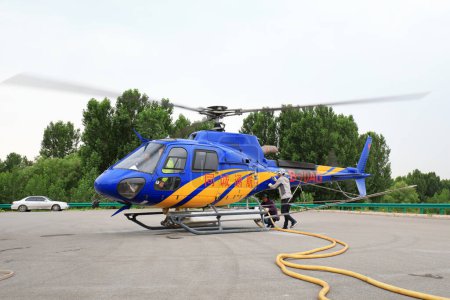 Photo for Luannan County, China - June 16, 2019: Agricultural helicopters loaded with pesticides, Luannan County, Hebei Province, China - Royalty Free Image