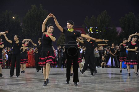 Photo for LUANNAN COUNTY, China - September 20, 2018: Social dance performance in the square at night, LUANNAN COUNTY, Hebei Province, China - Royalty Free Image