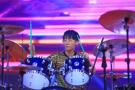 Photo for Luannan County - January 29, 2019: children  play drums on shelves on the stage, Luannan County, Hebei Province, Chin - Royalty Free Image