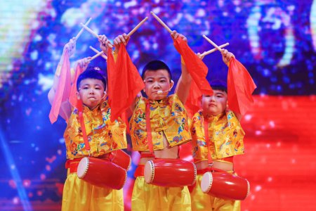 Photo for Luannan County - January 29, 2019: Children waist drum performance on the Stage, Luannan County, Hebei Province, China - Royalty Free Image