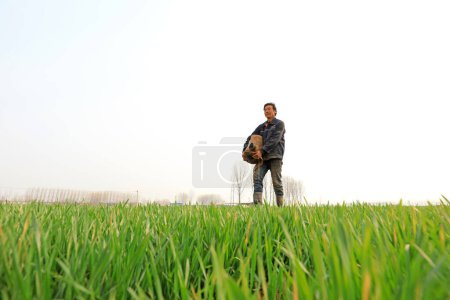 Téléchargez les photos : COMTÉ DE LUANNAN, Province du Hebei, Chine - 31 mars 2020 : Les villageois transportent des ceintures d'eau pour arroser le blé. - en image libre de droit