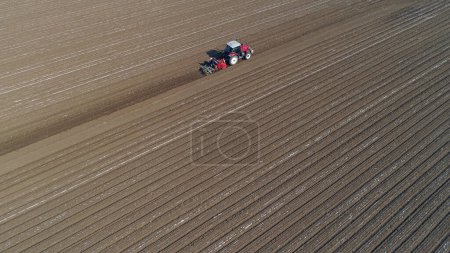 Photo for Farmers drive planters to plant Plastic Mulched peanuts in North China - Royalty Free Image