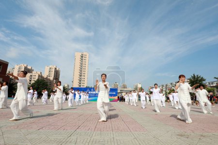 Photo for LUANNAN COUNTY, Hebei Province, China - August 8, 2020: People are practicing Taijiquan in the squar - Royalty Free Image