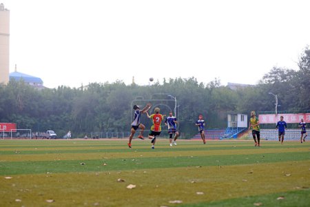Photo for LUANNAN COUNTY, Hebei Province, China - August 14, 2020: The students are practicing Rugby on the playground - Royalty Free Image