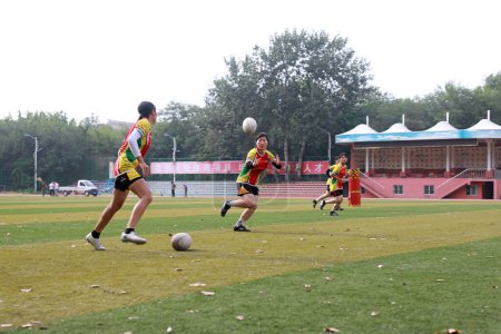Photo for LUANNAN COUNTY, Hebei Province, China - August 14, 2020: The students are practicing Rugby on the playground - Royalty Free Image