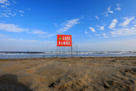 Photo for LETING COUNTY, Hebei Province, China - September 13, 2020: "Dangerous, no swimming" is written on the red sign, on the beach - Royalty Free Image